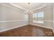 Empty Dining Room with hardwood floors, decorative ceiling trim, and a chandelier at 5115 Waterloo Dr, Fort Mill, SC 29708