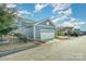 View of the spacious two-car detached garage with white doors and gray siding at 5115 Waterloo Dr, Fort Mill, SC 29708