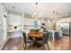 Bright kitchen with wooden dining table, stainless steel appliances, granite countertops, and hardwood floors at 5115 Waterloo Dr, Fort Mill, SC 29708