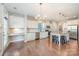 Bright kitchen features stainless steel appliances, granite countertops, a center island, and hardwood floors at 5115 Waterloo Dr, Fort Mill, SC 29708