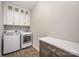 Bright laundry room featuring front load washer and dryer and ample cabinet space at 5115 Waterloo Dr, Fort Mill, SC 29708