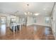 Open concept living area showcasing hardwood floors connecting the kitchen, living room and staircase at 5115 Waterloo Dr, Fort Mill, SC 29708