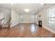 Bright living room with hardwood floors, a staircase, a fireplace, and large windows at 5115 Waterloo Dr, Fort Mill, SC 29708