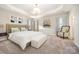 Staged primary bedroom featuring a tray ceiling, a large bed, and natural light at 5115 Waterloo Dr, Fort Mill, SC 29708