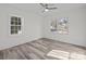 Bedroom with hardwood floors, ceiling fan and view of street at 529 Ambassador St, Charlotte, NC 28208