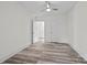 Bright bedroom with wood-look floors, ceiling fan, and ample closet space at 529 Ambassador St, Charlotte, NC 28208