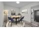 Bright dining room with table and chairs, hardwood floors, and view into kitchen at 529 Ambassador St, Charlotte, NC 28208