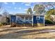 Charming blue house with a sunroom and a wooden deck at 529 Ambassador St, Charlotte, NC 28208