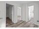 Bright hallway with hardwood floors and access to bedrooms and bath at 529 Ambassador St, Charlotte, NC 28208