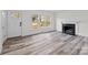 Bright living room with fireplace and grey wood-look floors at 529 Ambassador St, Charlotte, NC 28208