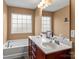 Bathroom with double vanity, soaking tub, and window at 5636 Whitehawk Hill Rd, Mint Hill, NC 28227