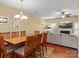 Bright dining room with wood table and chairs, adjacent to living room with fireplace at 5636 Whitehawk Hill Rd, Mint Hill, NC 28227