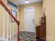 Bright entryway with hardwood floors, staircase, and a wooden console table at 5636 Whitehawk Hill Rd, Mint Hill, NC 28227