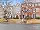 Three-story townhouses in a desirable neighborhood with brick and stone exteriors at 5636 Whitehawk Hill Rd, Mint Hill, NC 28227