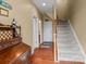 Hallway with hardwood floors, leading to stairs and other rooms at 5636 Whitehawk Hill Rd, Mint Hill, NC 28227