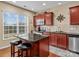 Modern kitchen boasts stainless steel appliances and a granite island with seating at 5636 Whitehawk Hill Rd, Mint Hill, NC 28227