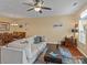 Open living and dining area featuring hardwood floors, a neutral color palette, and ample natural light at 5636 Whitehawk Hill Rd, Mint Hill, NC 28227