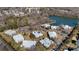 Overhead view of Harris Lake condos featuring waterfront views, trees and ample parking at 5818 Harris Grove Ln, Charlotte, NC 28212