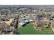 Aerial view of homes bordering Harris Lake with mature trees in a well-maintained community at 5818 Harris Grove Ln, Charlotte, NC 28212