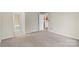 The bedroom is spacious and bright, showcasing doorways to the bathroom and kitchen at 5818 Harris Grove Ln, Charlotte, NC 28212