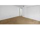 This bedroom offers carpeted floors, a large closet, and bright, white walls at 5818 Harris Grove Ln, Charlotte, NC 28212