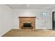 Cozy living room with a brick fireplace, mantle and a large window with shutters at 5818 Harris Grove Ln, Charlotte, NC 28212