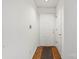 Clean, well-lit hallway with hardwood floors and a white front door at 5818 Harris Grove Ln, Charlotte, NC 28212