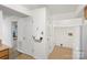 Hallway with multiple doors including an entrance to a utility room at 5818 Harris Grove Ln, Charlotte, NC 28212