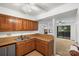 Open kitchen featuring wood cabinets and a pass-through to the living area at 5818 Harris Grove Ln, Charlotte, NC 28212