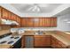 Functional kitchen with wood cabinets and a range at 5818 Harris Grove Ln, Charlotte, NC 28212