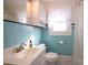 Bathroom with light blue tiled walls and a pedestal sink at 617 York S Ave, Rock Hill, SC 29730