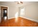 Bedroom with hardwood floors, ceiling fan and access to another room at 617 York S Ave, Rock Hill, SC 29730