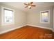 Bedroom with hardwood floors, ceiling fan, and two windows at 617 York S Ave, Rock Hill, SC 29730