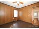 Bright bedroom with wood paneling, ceiling fan and access to hallway at 617 York S Ave, Rock Hill, SC 29730