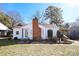 White house with brick chimney, landscaping, and carport at 617 York S Ave, Rock Hill, SC 29730