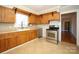 Kitchen with wood cabinets, tile floor, and stainless steel stove at 617 York S Ave, Rock Hill, SC 29730