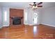 Living room with hardwood floors, brick fireplace, and ceiling fan at 617 York S Ave, Rock Hill, SC 29730