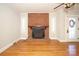 Living room featuring hardwood floors, brick fireplace, and door at 617 York S Ave, Rock Hill, SC 29730