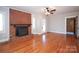 Living room with hardwood floors, brick fireplace, and ceiling fan at 617 York S Ave, Rock Hill, SC 29730