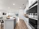 Modern kitchen with stainless steel appliances and white cabinetry at 642 Citriadora St, Fort Mill, SC 29715