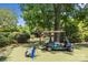 Landscaped backyard with golf cart and putting green at 7213 Fairway Vista Dr, Charlotte, NC 28226