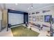 Finished basement with golf simulator, gym equipment, and sports memorabilia at 7213 Fairway Vista Dr, Charlotte, NC 28226