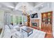 Spacious living room with hardwood floors, fireplace, and built-in shelving at 7213 Fairway Vista Dr, Charlotte, NC 28226