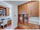 Functional mudroom with built-in cabinets, hooks, and a workspace at 7213 Fairway Vista Dr, Charlotte, NC 28226