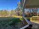 The home's deck overlooks a grassy backyard surrounded by lush trees, offering privacy and tranquility at 8768 Sherrills Ford Rd, Sherrills Ford, NC 28673