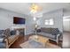 Living room featuring hardwood floors, a fireplace, and a decorative ceiling fan at 9635 Veronica Dr, Charlotte, NC 28215