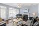 Cozy living room area with a fireplace, large windows, and a ceiling fan at 9635 Veronica Dr, Charlotte, NC 28215