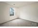 Well-lit bedroom with neutral carpeting and window at 10306 Creswell Ct, Charlotte, NC 28215