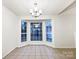 Dining area with tile flooring and bay window at 10306 Creswell Ct, Charlotte, NC 28215