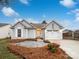 Gray exterior boasts a two-car garage and landscaped front yard at 10306 Creswell Ct, Charlotte, NC 28215